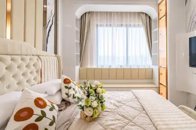 Luxurious bedroom with elegant decor and large window seating area