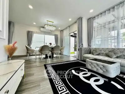 Luxurious modern living room with elegant decor and stylish furniture, featuring a chic dining area and large windows.