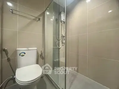 Modern bathroom with glass shower enclosure and sleek tile design