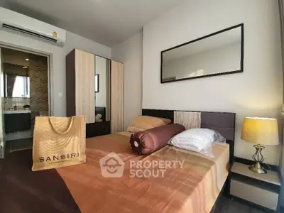 Modern bedroom with stylish decor and ample natural light, featuring a cozy bed and elegant furnishings.