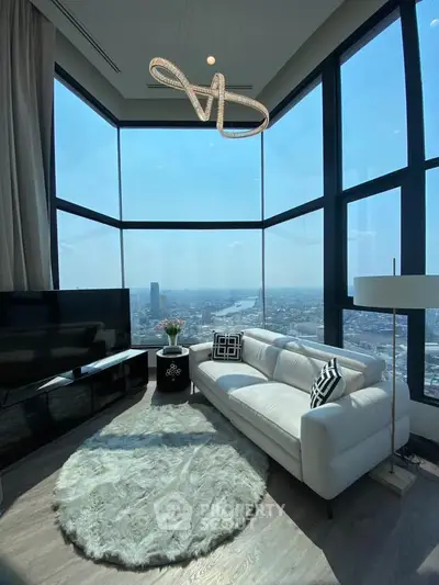 Luxurious corner unit living room with panoramic city views and modern decor.