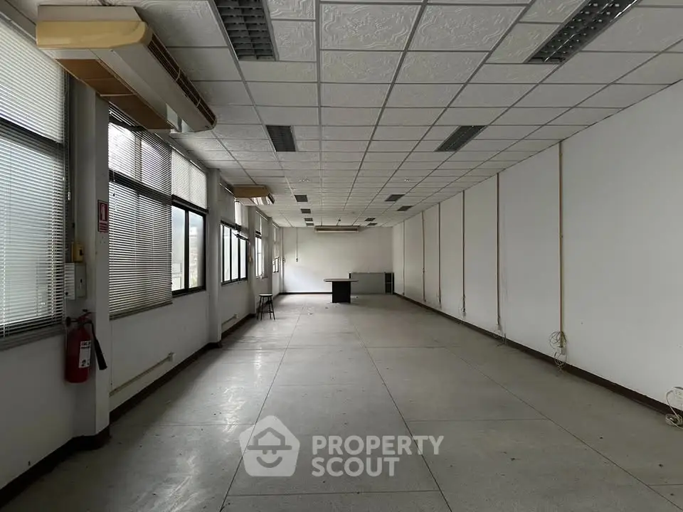 Spacious office space with large windows and ample natural light, ideal for business setup.
