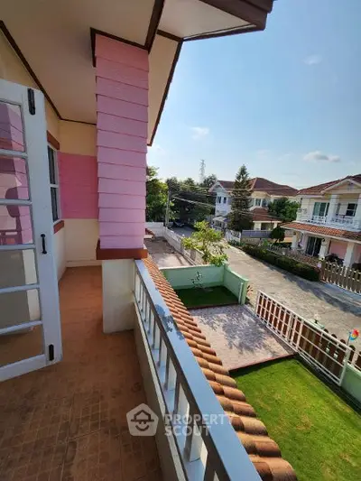Charming balcony view overlooking a suburban neighborhood with lush greenery.