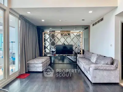 Spacious modern living room with elegant decor and large windows