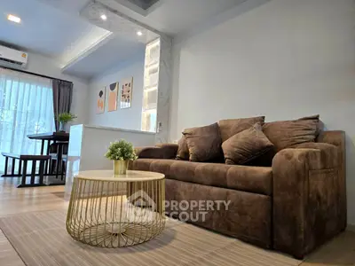 Modern living room with cozy brown sofa and stylish decor