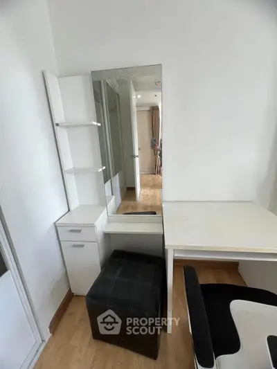 Modern study area with sleek desk and mirror in bright apartment