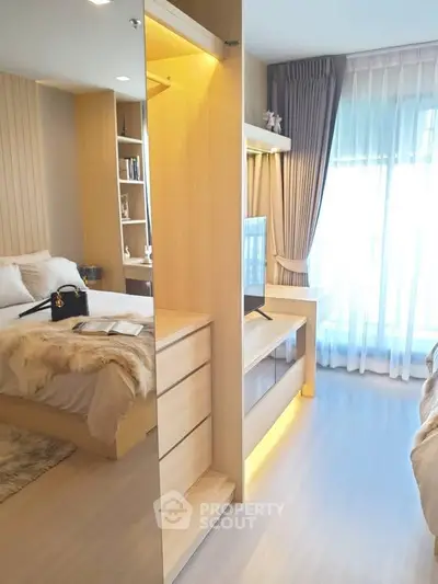 Modern bedroom with natural light, cozy decor, and stylish furnishings in a contemporary apartment.