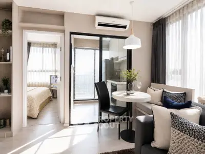 Modern open-plan living room with dining area and view into bedroom, featuring stylish decor and natural light.