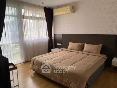 Spacious bedroom with large windows and modern decor