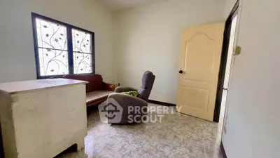 Cozy room with vintage furniture and decorative window grilles, perfect for a quaint living space.