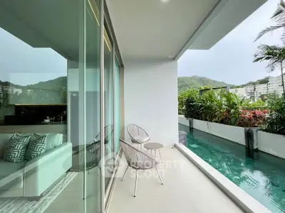 Luxurious balcony with pool view and modern seating, surrounded by lush greenery and scenic hills.