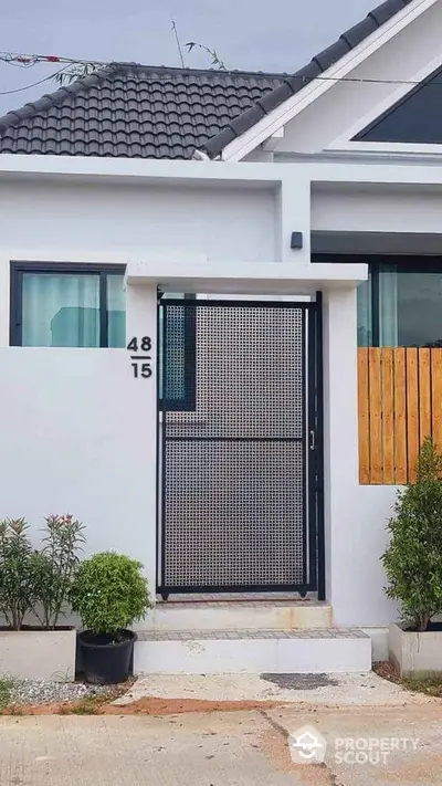 Modern house entrance with sleek gate and minimalist design