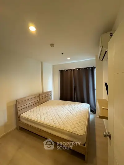 Cozy bedroom with modern furnishings and natural light, perfect for relaxation and comfort.