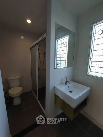 Modern bathroom with sleek sink and shower enclosure