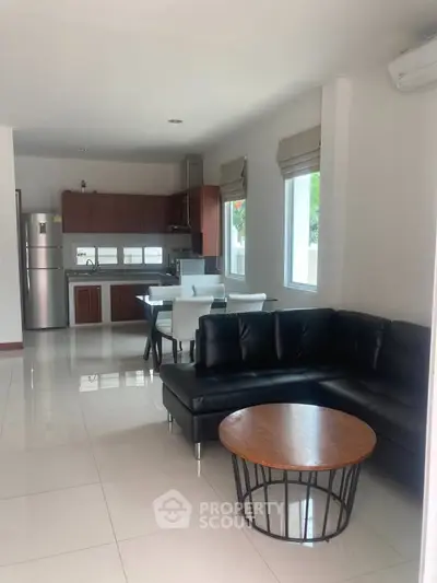 Spacious open-plan living room with modern kitchen and stylish furniture