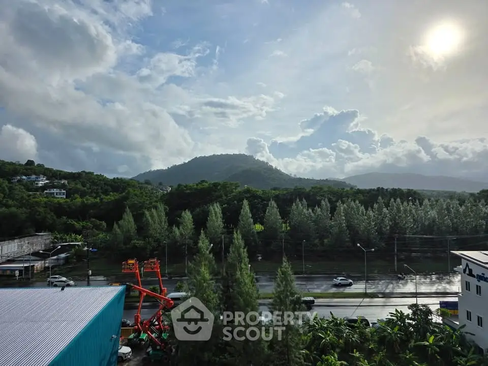 Scenic view of lush green landscape with mountains and cloudy sky