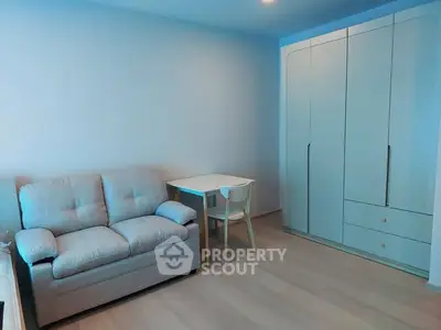 Cozy living room with modern sofa and sleek wardrobe, perfect for urban living.