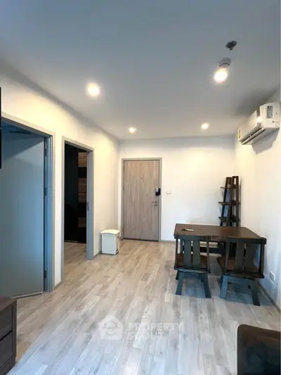 Modern apartment interior with wooden flooring and minimalist furniture