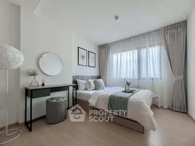 Modern bedroom with elegant decor, featuring a cozy bed, stylish desk, and large window with natural light.