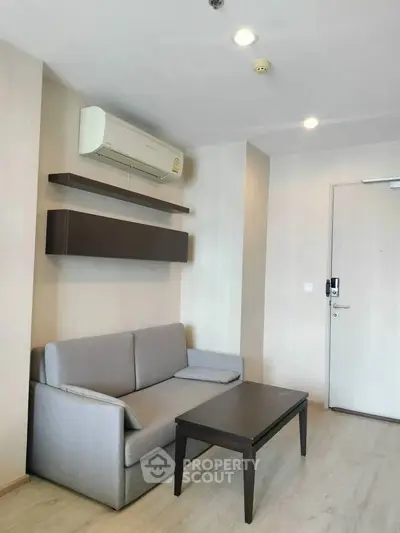 Modern living room with sleek furniture and air conditioning in a stylish apartment.