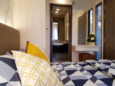 Modern bedroom with stylish decor and ensuite bathroom in luxury apartment