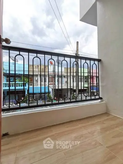 Charming balcony with stylish railing and city view, perfect for relaxing outdoors.