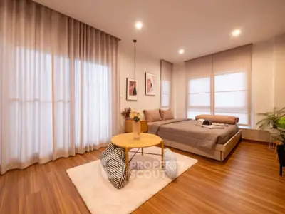 Spacious modern bedroom with cozy decor and natural light