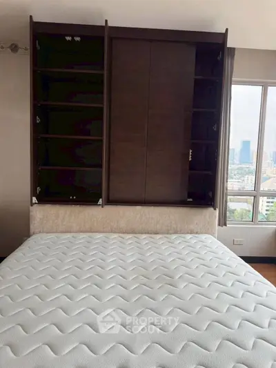 Spacious bedroom with city view and built-in wardrobe