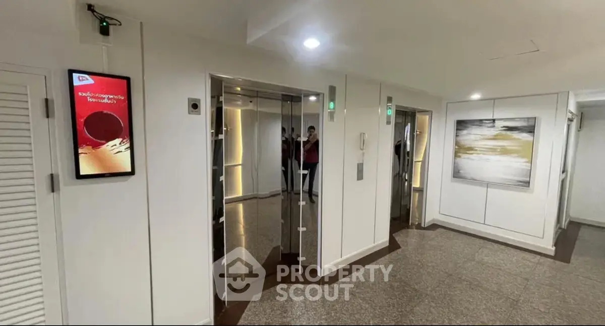 Modern elevator lobby with sleek design and contemporary artwork