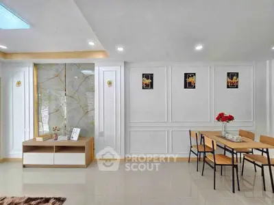 Modern dining area with elegant wall paneling and stylish furniture in a bright, spacious room.