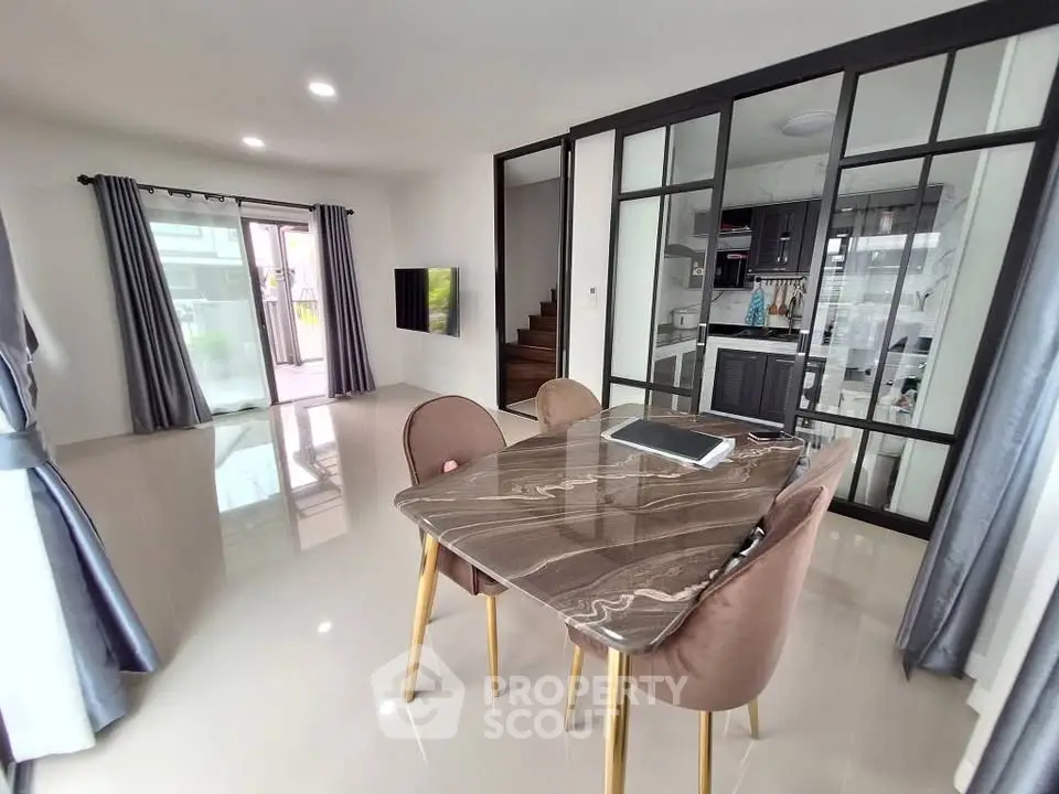 Modern open-plan living room with elegant dining area and stylish kitchen.
