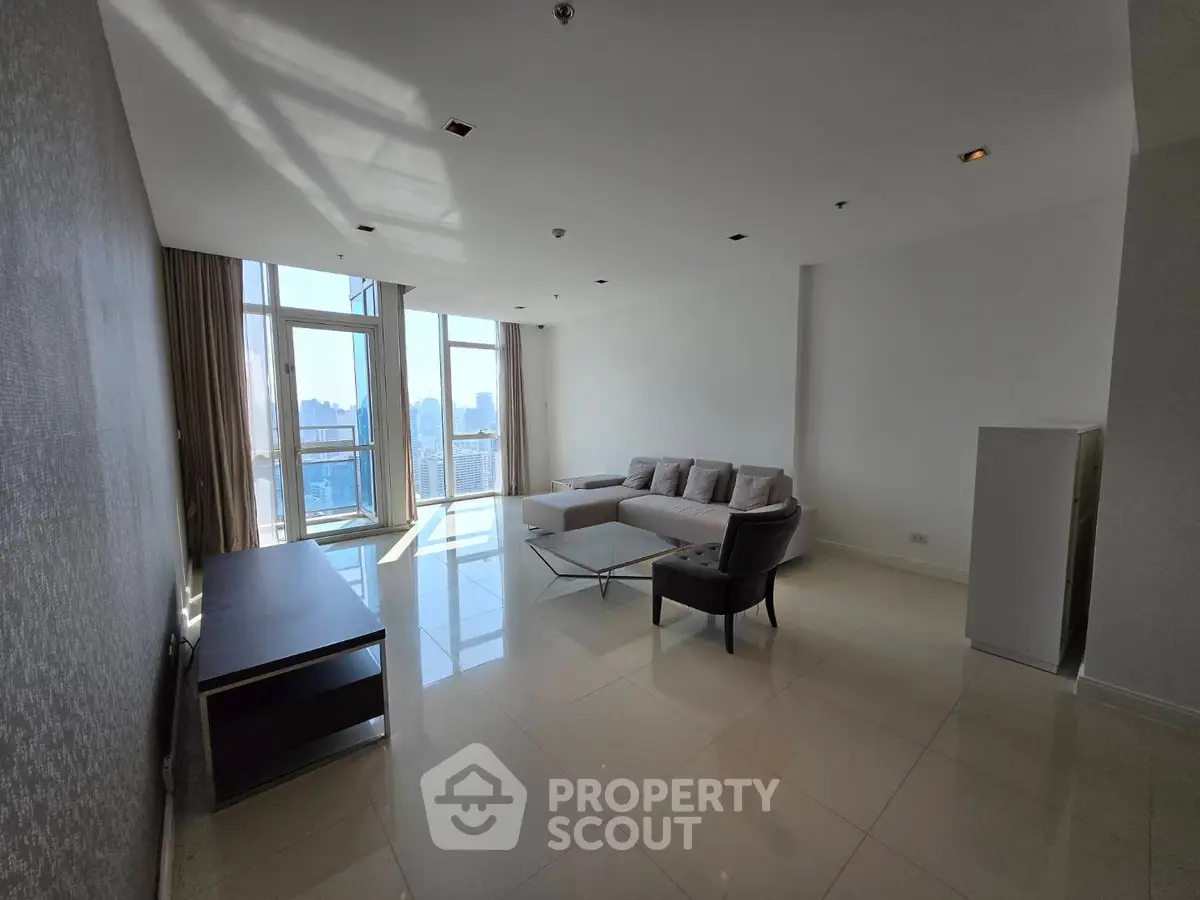 Spacious modern living room with large windows and city view