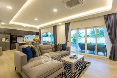 Spacious modern living room with open kitchen and garden view