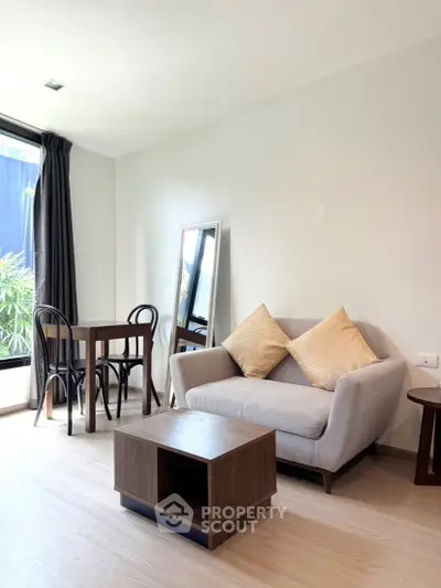 Modern living room with cozy sofa and dining area in bright apartment
