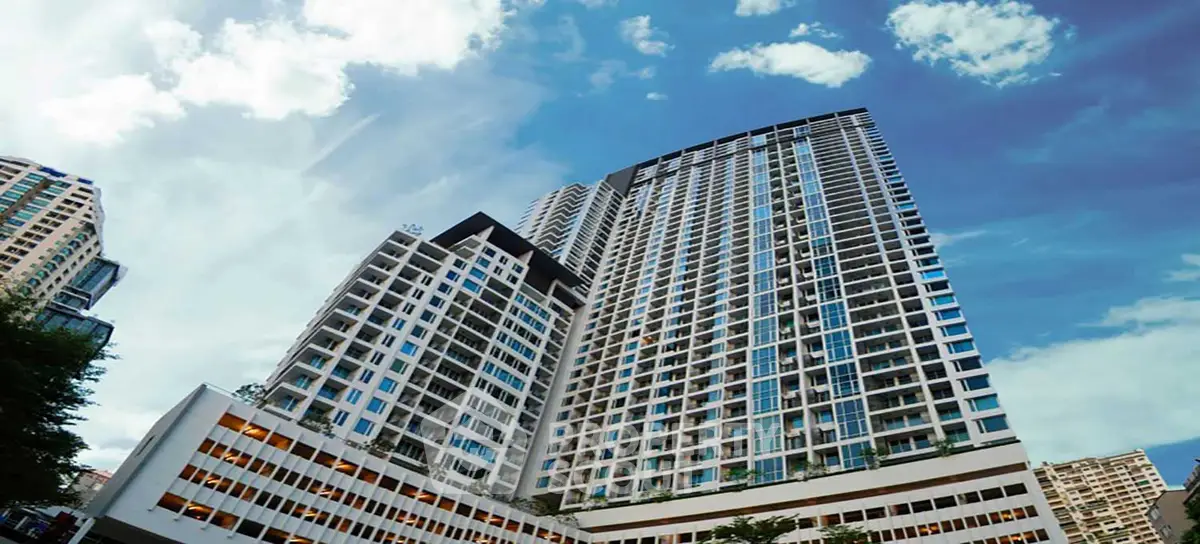 Stunning high-rise building with modern architecture against a vibrant blue sky.