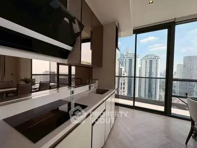 Modern kitchen with sleek design and stunning city view from large windows.