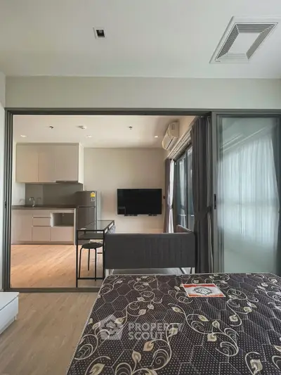 Modern open-plan living room with kitchen and stylish decor in a contemporary apartment.