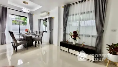 Spacious and elegant living room with gleaming tiled floors, modern furniture, and abundant natural light from large windows, perfect for family gatherings.