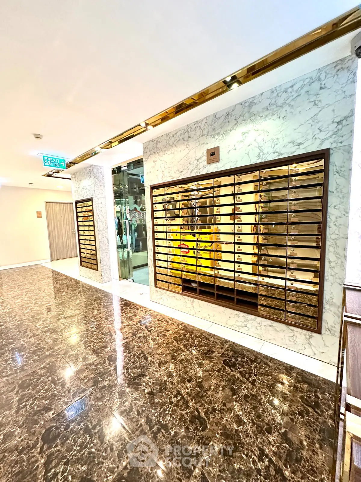 Luxurious marble-floored lobby with modern mailboxes and elegant lighting
