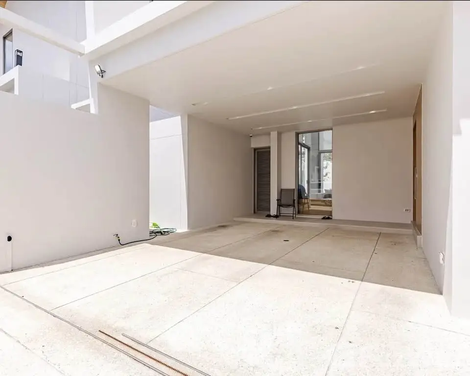 Spacious modern garage with sleek design and ample natural light, perfect for urban living.