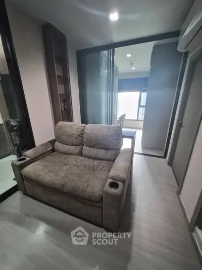 Cozy living room with plush sofa and modern decor in a stylish apartment.