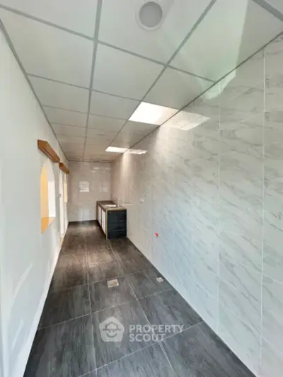 Modern kitchen with sleek tile flooring and ample natural light