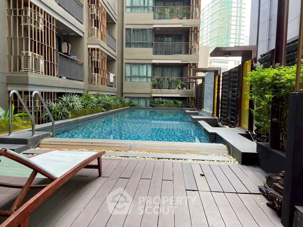 Luxurious urban apartment with modern pool and lush greenery, perfect for relaxation and city living.
