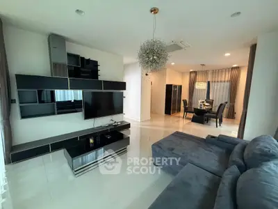 Modern living room with sleek black entertainment unit and cozy dining area