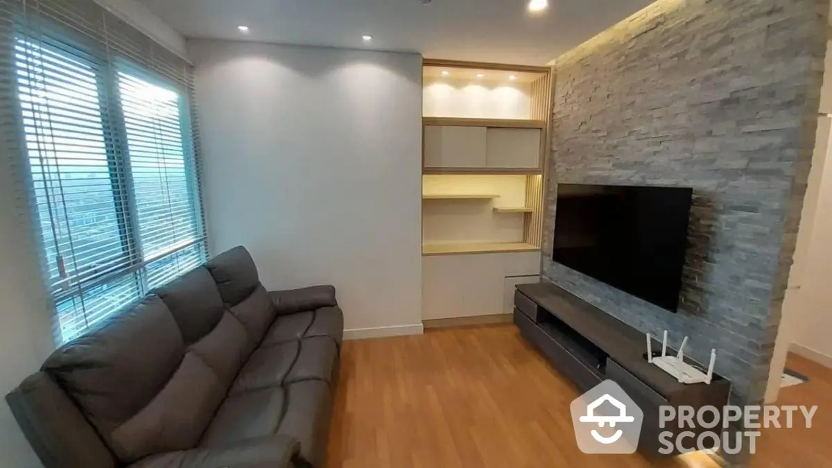 Modern living room with sleek sofa and built-in entertainment unit