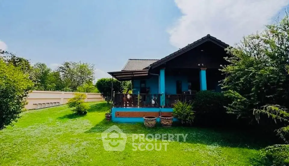 Charming single-story home with lush green garden and spacious porch, perfect for serene living.
