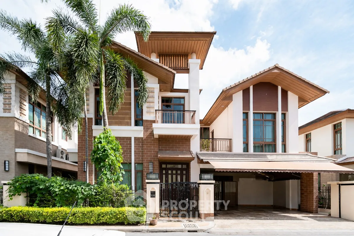 Stunning modern house with lush greenery and spacious carport in a serene neighborhood.