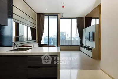 Modern open-layout living room with city view and sleek kitchen design.