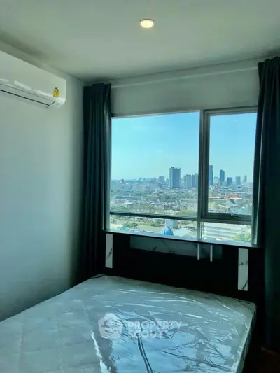 Modern bedroom with city view and large window, featuring air conditioning and sleek design.
