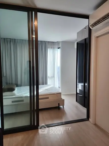 Modern bedroom with sliding glass doors and natural light